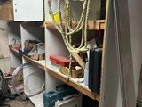a room with a lot of clutter and tools on the shelves