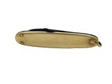 a close up of a knife with a gold handle on a white background