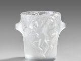 a glass vase with a design on it on a table