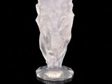 a glass vase that is sitting on a black surface