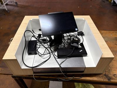 a laptop computer sitting in a box on top of a table