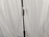 a black tripod on a white background with a white curtain