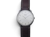 a close up of a wrist watch on a white surface