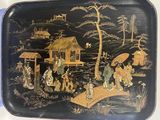 a black tray with a painting of people on it