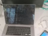 a laptop computer sitting on a desk next to a cell phone