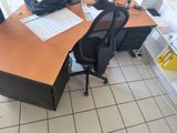 a desk with a chair and a computer on it