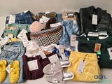 a lot of clothes and shoes that are on a table