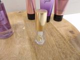 a wooden table with a bottle of perfume and a bottle of body lotion on it