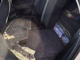 a white car with a broken door and a broken window