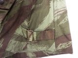 a close up of a camouflage jacket with a metal buckle