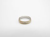 a silver and gold ring on a white background