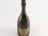 an old bottle of champagne sitting on a white surface