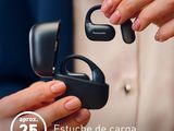 a woman holding a pair of ear buds in her hands