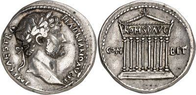 a silver coin with an image of a woman and a building on it