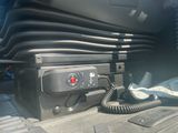 an image of a car ' s trunk with a phone in it