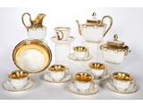 an image of a group of white and gold dishes and cups