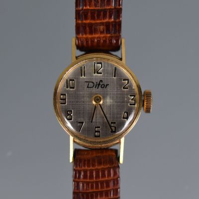 an image of a close up of a wrist watch on a table