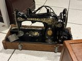 a black and gold sewing machine on display in a room