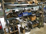 many different types of tools on the shelves in the garage