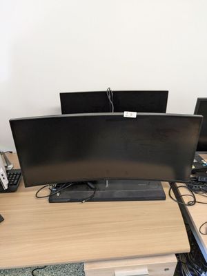 a desk with two monitors and a keyboard on it