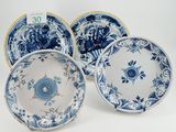 three blue and white plates with floral designs on them
