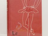 the book is red and has a drawing of a woman in a tutu