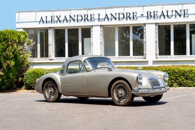 a silver car parked in front of a building