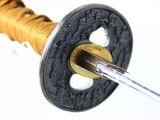 a picture of a close up of a sword with a blade