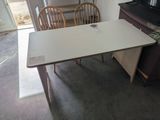 a table and chairs in a room with a television