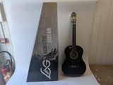 a guitar sitting next to a box with a guitar on it