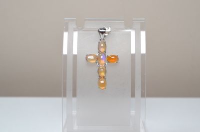 a small cross in a clear box on a table