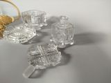 four pieces of glass sitting on a table next to a basket