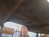 a suitcase that is sitting on the ground under a bridge