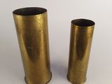 a pair of brass vases sitting on top of a white table