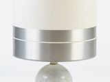 a lamp that is sitting on a table with a white shade