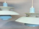 two lamps hanging from the ceiling in a room