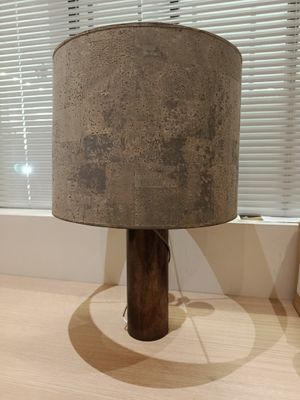 a lamp that is sitting on a table in front of a window