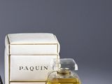 a bottle of perfume and a box of perfumes on a table