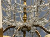 a gold chandelier with crystal beads hanging from it