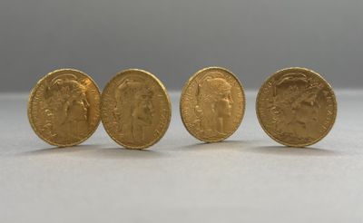 three gold sovereigns sitting next to each other on a table