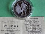 a silver coin with a picture of a soldier on it