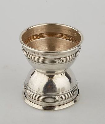 an antique silver plated bowl on a stand on a white surface