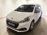 the small white car is parked in a large room