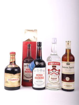 several bottles of liquor are lined up on a white surface