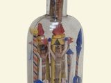 a glass bottle with a picture of people inside of it