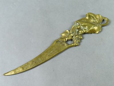 gold plated dagger with a lion on it and a bird on the blade
