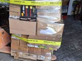 a pile of boxes on a pallet in a garage