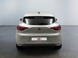 the rear end of a silver car in a white room
