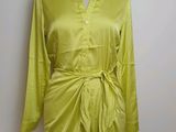lime green shirt dress on a mannequin stand