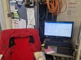 a red chair with a laptop on it in a room